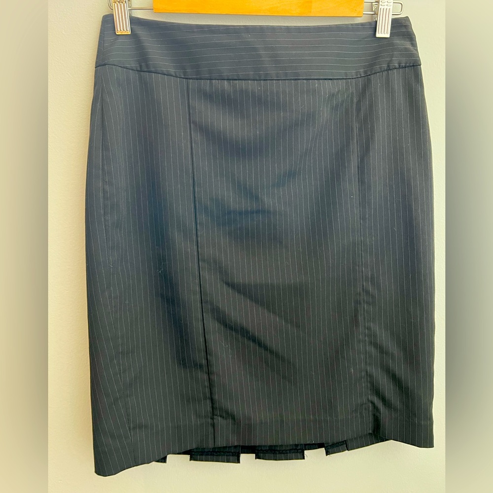Black Pinstripe pencil skirt with adorable ruffle detail on back.